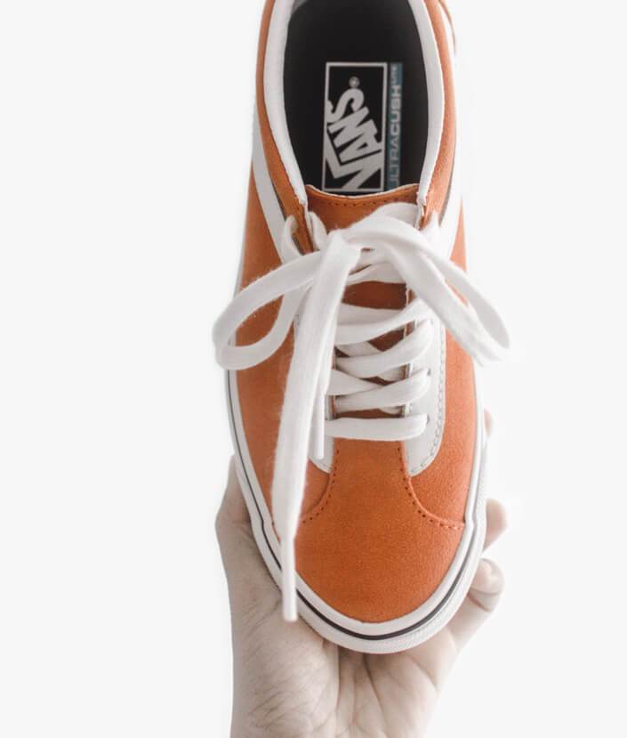 Red Vans sneaker with white laces made from canvas